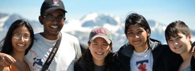 Five UUֱ students pose in front of mountains.